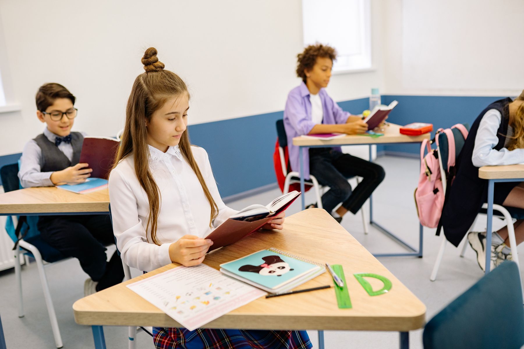 School-age children reading together in a classroom